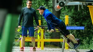 Two happy men training at Omnigym outdoor gym in Helsinki